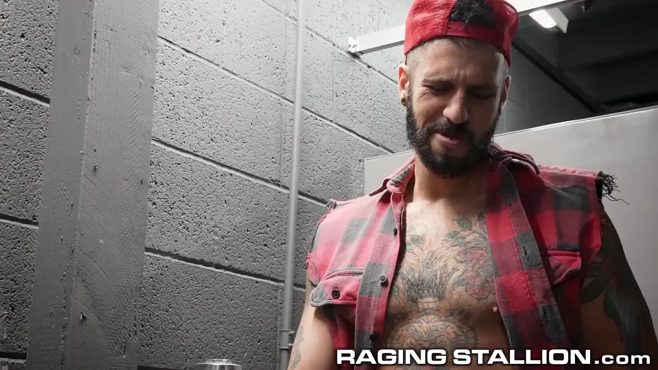 Three muscular tattooed gay men have a bareback threesome in the public bathroom