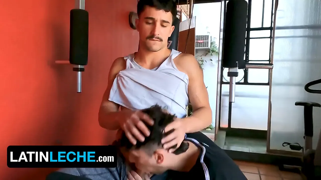 Muscle Latino works out his body while tattooed gay man strokes his big dick