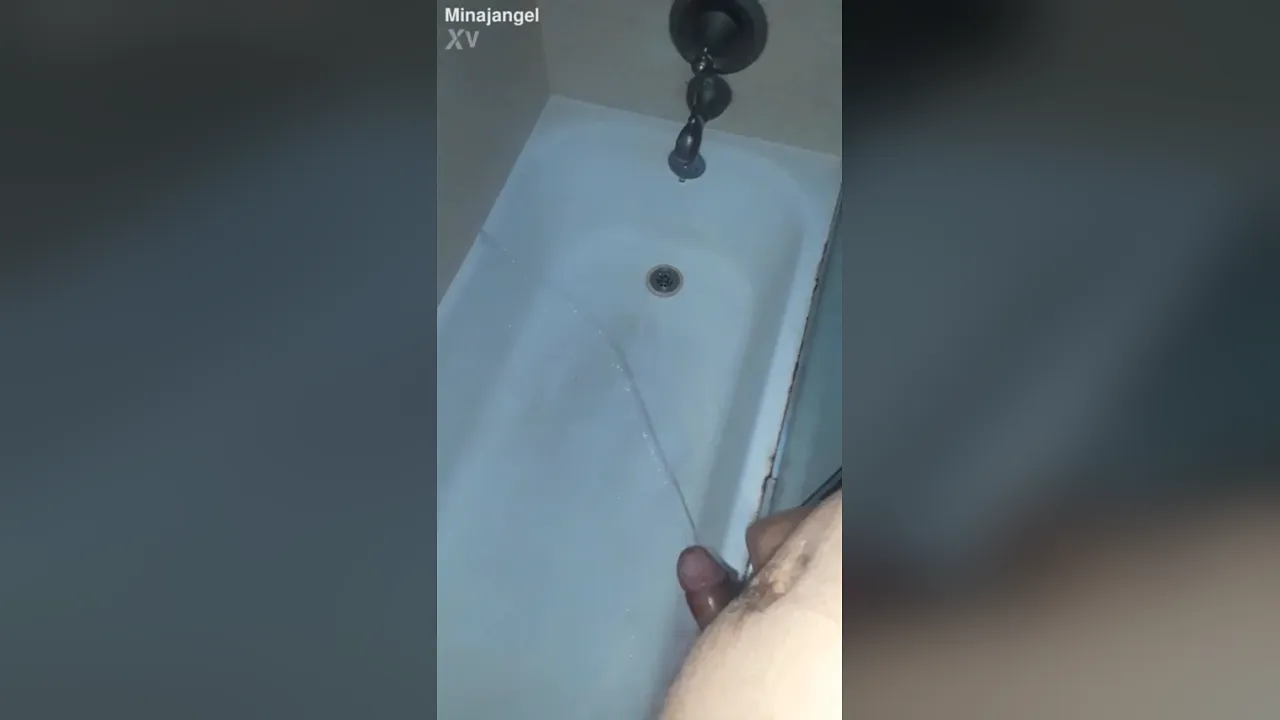 Gay guy pisses into bathtub while wearing stockings