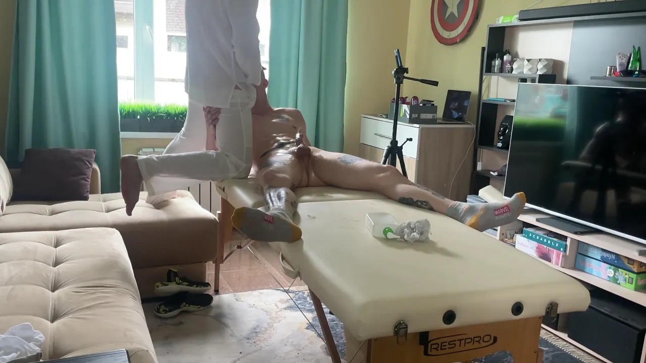 Gay masseur gives blowjob and handjob to client during massage session